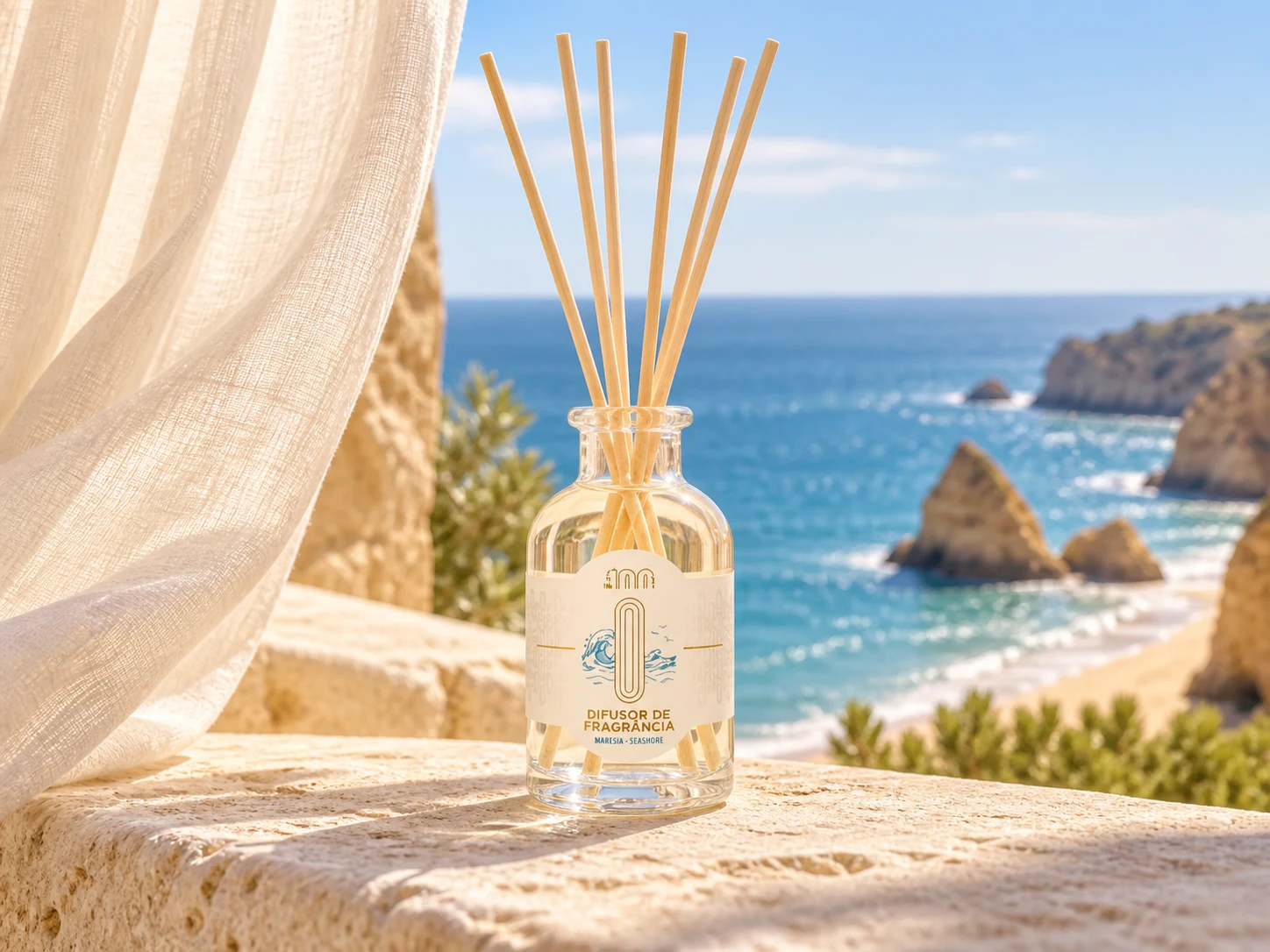 The 100s Maresia reed diffuser in a bright seaside setting